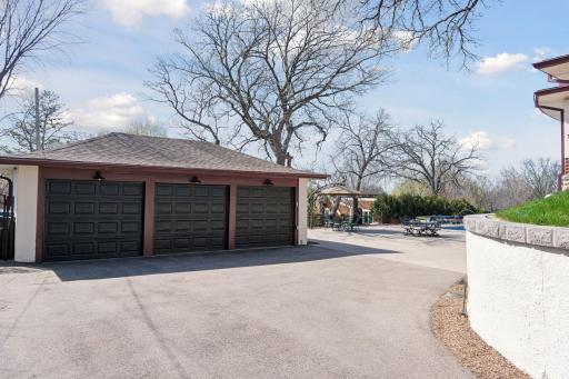 Private driveway with a gated entrance opens to the three car garage. Garage conveniently located to the lower level mudroom with custom built-ins.
