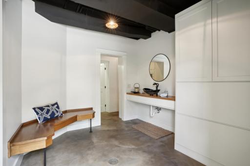 Large poolside bathroom shower finished in custom concrete micro-topping is both beautiful and durable.