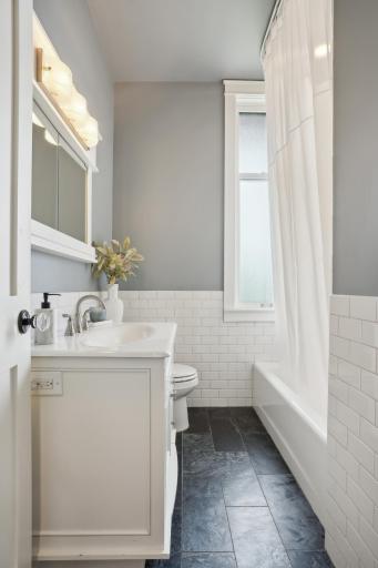 Guest/main floor full bath has been fully updated while retaining it's original charm. Don't forget to try out the custom pull out step stool built into the front base of the vanity. Nothing has been overlooked in this home.