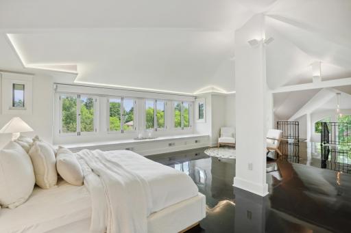 Expansive 1000 square foot primary suite features indirect LED lighting, as well as remote-controlled blackout and partial blackout blinds. The panoramic treetop views take you out of the city and into your own private oasis.