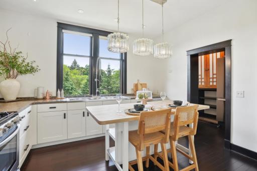 Kitchen with center island, ample countertop space and sturdy cabinet drawers complete with organizers.