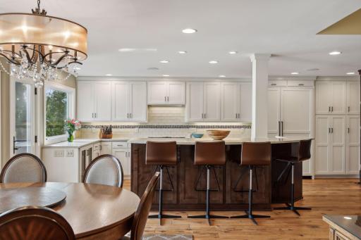 State of the art kitchen offers plenty of storage including under the island cabinets, Dual wine coolers and Meile gas cooktop with down draft ventilation.