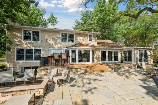 Exquisite paver patio great for entertaining. Complete with ambient lighting, sound system, custom bar top, fireplace & EVO grill