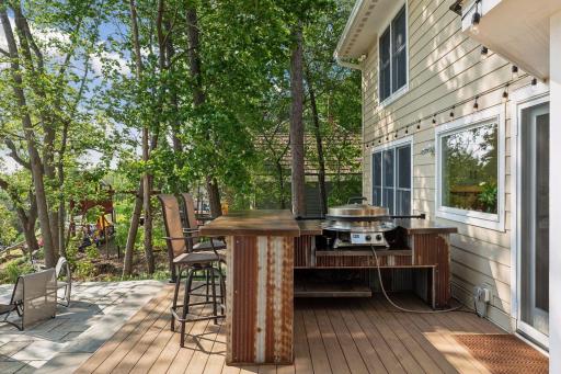 Custom-built outdoor bar made from the same acid washed steel used in the living room and EVO grill. Sellers are including the custom made canvas cover.