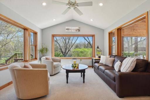 Sure to be one of the favorite rooms, the sun room features vaulted ceiling and is wrapped in windows with private views