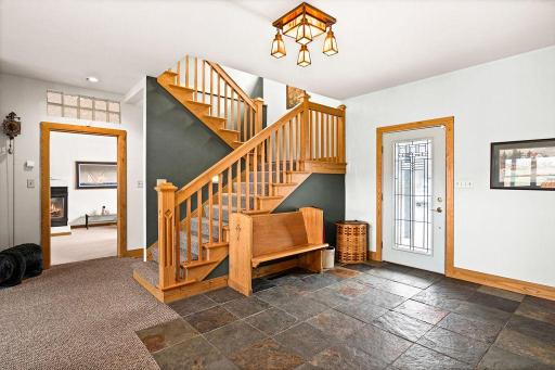 The woodwork in this foyer is really elegant and the slate tile adds to the earthen tones.