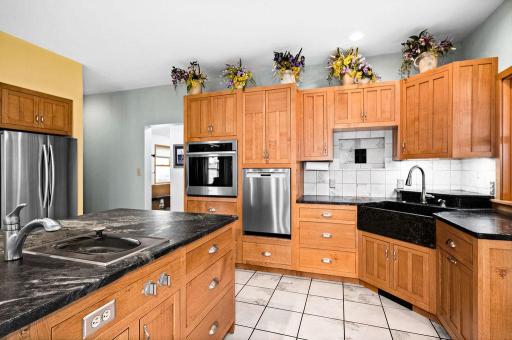 The island has a custom 2'x3.5' sink with reverse osmosis water supply and a built-in Gagganau contertop steamer with a hot/cold water tap and motorized drain.