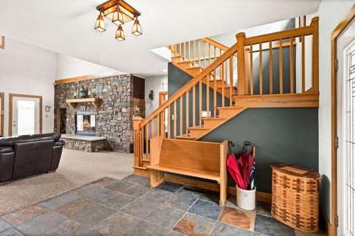Large, welcoming foyer, with custom white oak woodwork throughout the home.