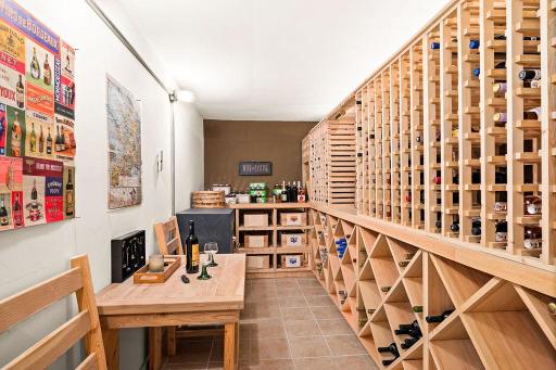 This wine cellar is 24' long. All four walls are poured concrete, which provides the cellar with an even natural climate of 55+ degrees year round.