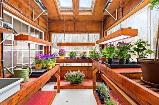 Adjacent to the kitchen is a greenhouse that measures 8x10'. The room is vaulted up to 12', with in-floor heat and heated grow mats.