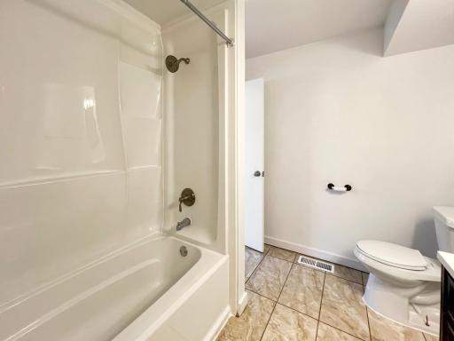 Updated bathroom includes ceramic tile and large shower/tub combo.