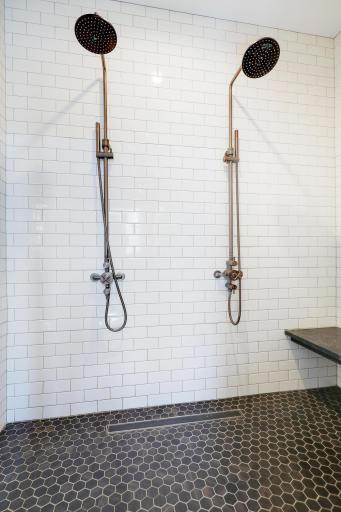 Luxurious walk-in shower, with dual shower heads, bench and large shelf