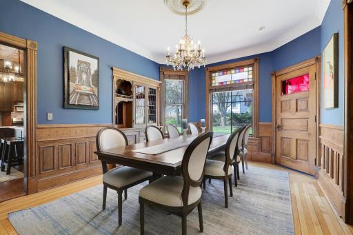 Generous sized dining room with bay window, built-in hutch, pocket doors, and sweet details on paneling