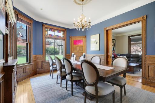 Generous sized dining room with bay window, built-in hutch, pocket doors, and sweet details on paneling
