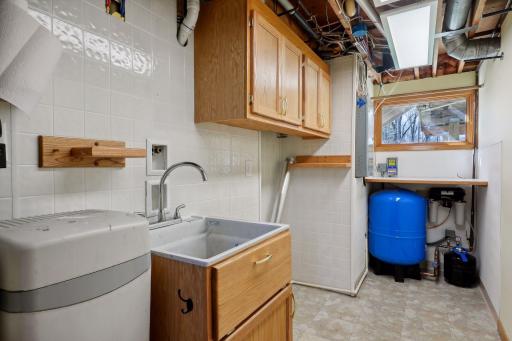 The utility room features washer/dryer hookups and a laundry sink. It has a reverse osmosis water system and a water softener with a 5-stage filter system. Additionally, a new well water tank was installed in 2022, & the ductwork was cleaned in 2024.