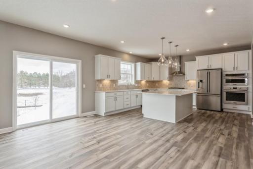 (Photo of a similar home, actual homes finishes will vary) Beautiful LVP flooring throughout great room and kitchen areas!
