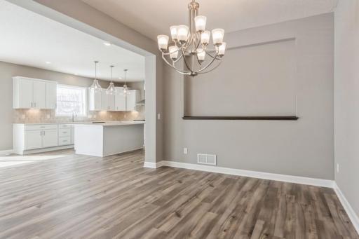 (Photo of a similar home, actual homes finishes will vary) Spacious, separate dining room with room for a large table conveniently located close to the kitchen for easy access while entertaining!