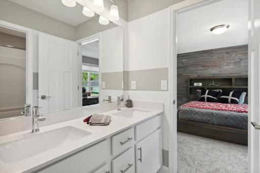 (Photo of decorated model, similar floor plan, colors, finishes and features will vary) The convenient, well-designed dual entry bathroom features a double-vanity with separate shower/tub area, offering two private spaces.