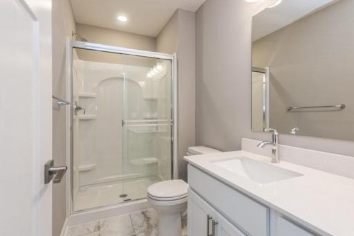 (Photo of a similar home, actual homes finishes will vary) This en-suite 3/4 bathroom bath provides extra privacy.