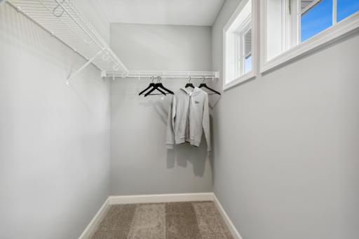 (Photo of decorated model, similar floor plan, colors, finishes and features will vary) The spacious closet featured in the secondary bedroom.