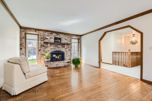 Welcoming great room with wood-pegged oak flooring. Brick fireplace with new gas insert in 2019.