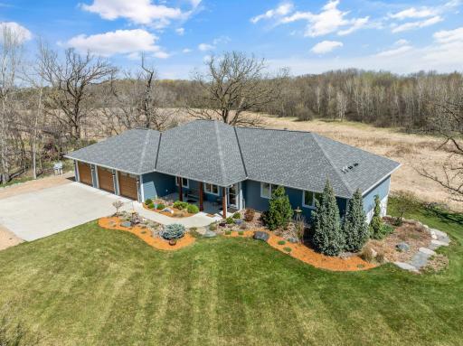 This aerial view shows you the stunning private setting this 3.98 acre homesite offers. On the left side of the home alongside the oversized garage is a large additional parking pad for an RV/Boat or any of your toys.