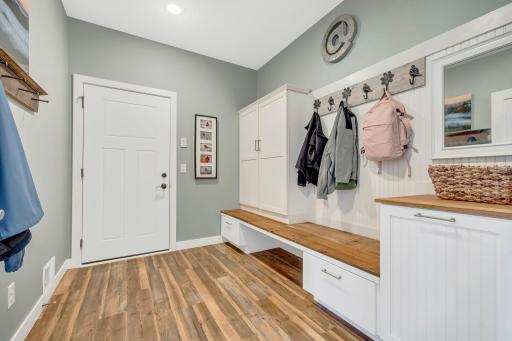 Check out this stunning mudroom with LVP flooring, custom bench and cabinetry all located just off the oversized heated 3 car garage. The garage is an amazing 38' wide x 32' deep! The 3rd stall is divided for a workshop area and has separate heater