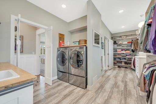 Genius custom design with access to the laundry area right from your primary bathroom, or the main level hallway. Front loading washer and dryer included with the sale and convenient folding area and sink.