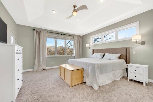 Primary Suite on Main Level with trey vault ceiling, ceiling fan, transom window, and picture window. There is also a door from the primary suite directly to the deck! Once you see the craftsmanship and views you will want to call this place home!