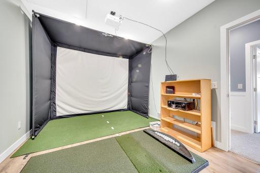 Lower level flex room is perfect for your hobby room or maybe an exercise space. Current golf simulator not included with sale.