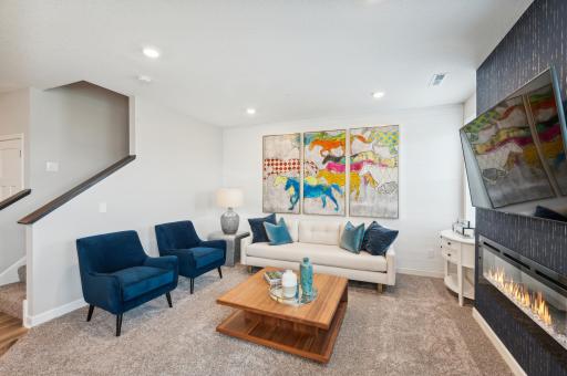(Photo is of a decorated model, actual homes finishes will vary) The main level great/family room provides a wonderful area for families to watch movies, enjoy a cozy fire or a place to just relax in conversation.