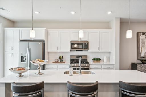 (Photo is of a decorated model, actual homes finishes will vary) Welcome to the St. Clair! This stunning kitchen provides plenty of space to cook and enjoy a lovely meal.