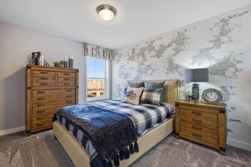 (Photo is of a decorated model, actual homes finishes will vary) The second upper level bedroom is also a nice size, offers a large window and closet.