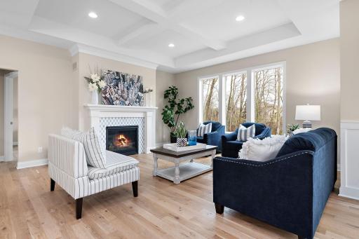 Great room with vaulted & beamed ceiling, real white oak hardwood floors & a pretty fireplace.