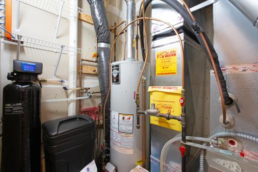 Braunworth utility room with water softener.