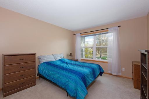 Upper level, bedroom two with double window. Drapery rod and blinds for privacy. Nice-sized closet for storage.