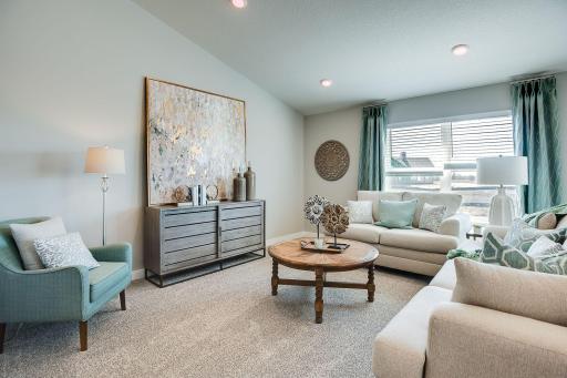 Cozy and comfortable living room, with ample space and natural light. Lots of space to relax. Photo of Model Home. Options and colors may vary. Ask Sales Agent for details.