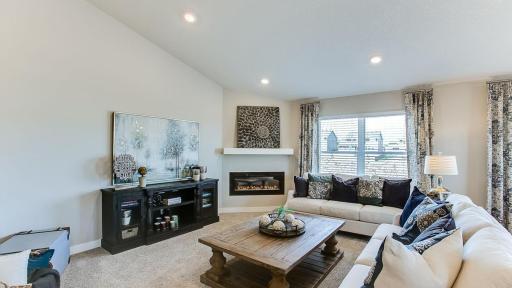 An electric burning fireplace completes the ambiance. Photo of Model Home. Options and colors may vary. Ask Sales Agent for details.