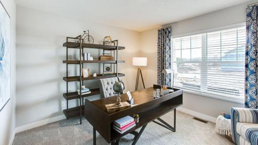 Main floor bedroom or flex room is located at the front of the home and has a large window for natural light and French doors. Photo of Model Home. Options and colors may vary. Ask Sales Agent for details.