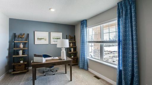 The bonus room on the main level can be used as a bedroom, home office, home gym, and more! So many possibilities! Photo of Model Home. Options and colors may vary. Ask Sales Agent for details.
