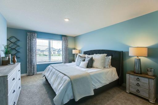 The Finnegan's primary bedroom is spacious and bright with not one-but two walk-in closets! Photos of model home. Colors and options may vary. Ask Sales Agent for details.