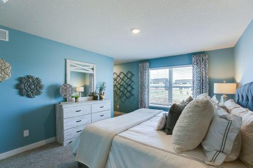 The very generous primary bedroom has plenty of space to fit your dream furniture set. Bedroom fits king-size furniture. Photo of Model Home. Options and colors may vary. Ask Sales Agent for details.