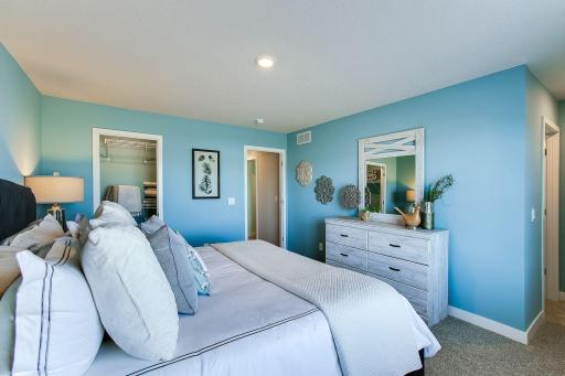 Another view of the primary bedroom in the Finnegan model with bathroom en-suite. Photos of model home. Colors and options may vary. Ask Sales Agent for details.