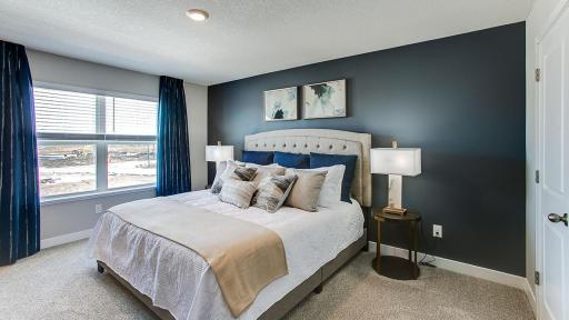 An oasis of its own, the primary suite offers the perfect escape. There's immediate access to a private bathroom that features dual sinks and a large shower. Photo is of model home. Colors and options may vary. Ask Sales Agent for details.