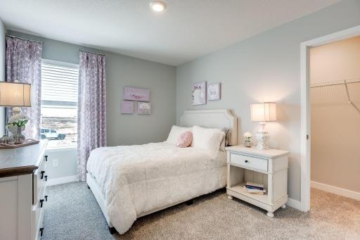 Another upper-level bedroom with abundant space and a walk-in closet! Photo of Model Home. Options and colors may vary. Ask Sales Agent for details.