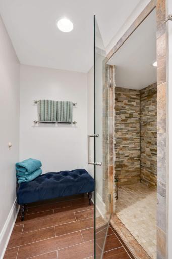 Appealing glass walk-in shower with beautiful natural stone!