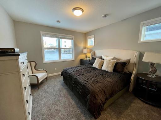 Photo of similar home, colors and finishes will vary. The spacious primary suite features a private bathroom and walk-in closet.
