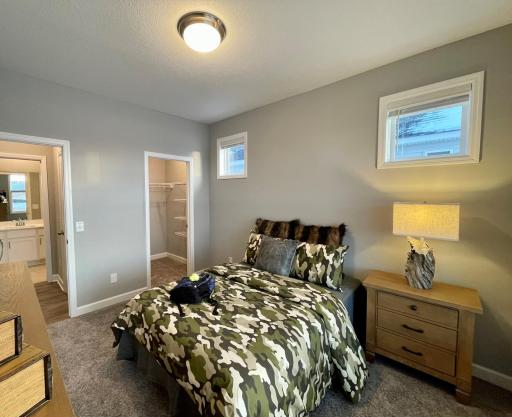 Photo of similar home, colors and finishes will vary. In addition to the primary bedroom there is one guest bedroom with a walk-in closet and a full guest bath. This guest bedroom is set up as an office.