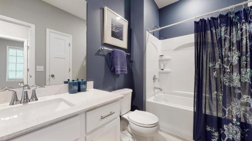 Photo of similar home, colors and finishes will vary. The full guest bath is adjacent to the guest bedroom and features quartz countertops.