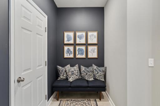 Photo of similar home, colors and finishes will vary. The mudroom is nicely sized and across from the bench is the coat closet.